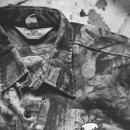 Camouflage jacket with DNO Skull logo on the chest. Closeup feat Redhead tag