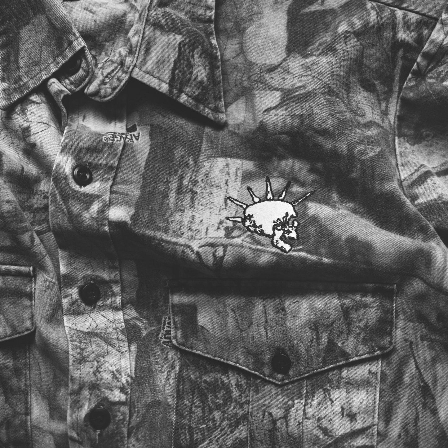 Camouflage jacket with DNO skull logo on the chest